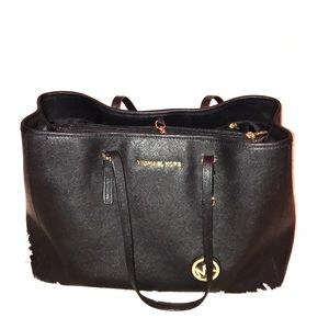 Michael Kor’s book bag with gold emblems